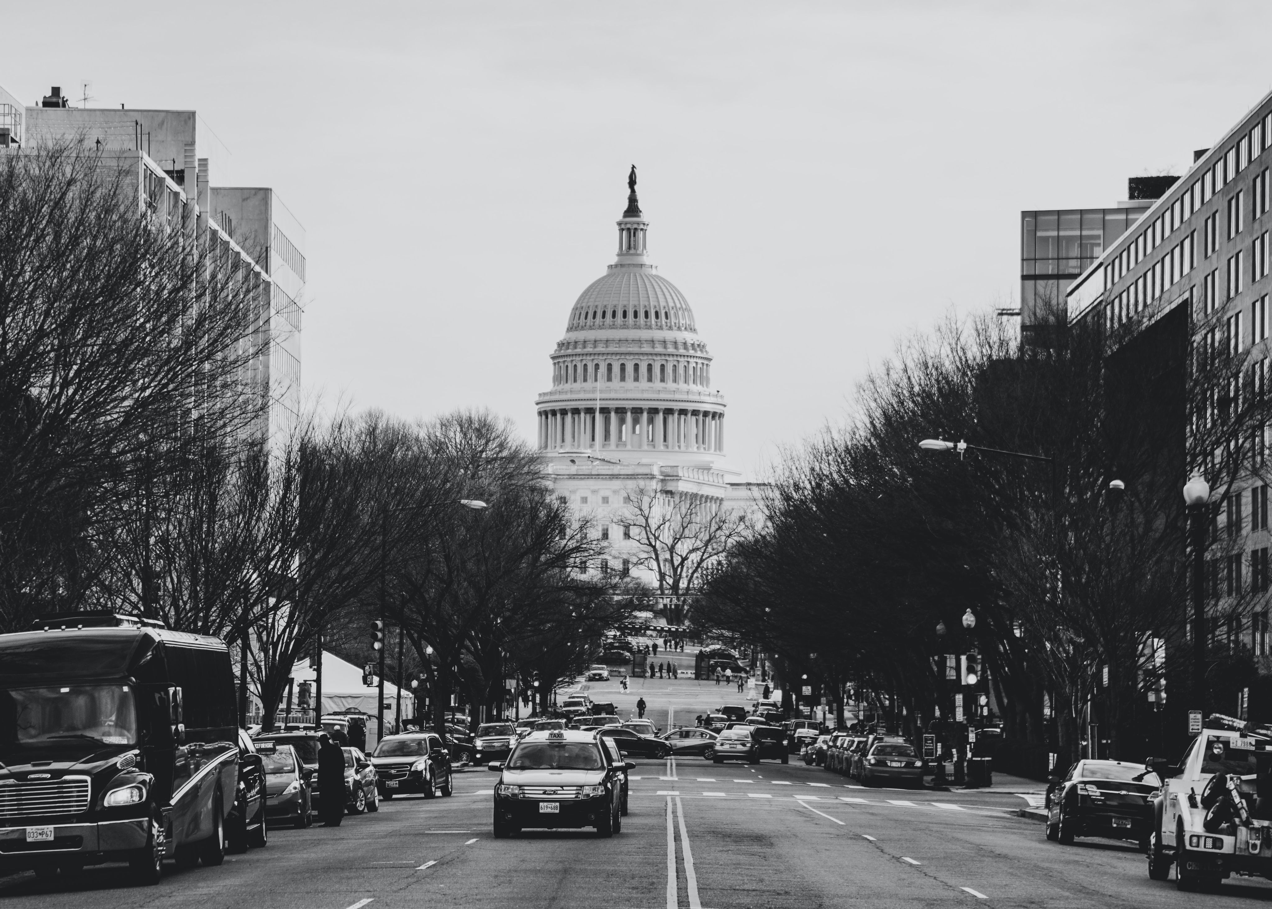 cars and bus parked at roadside near Capitol Hill